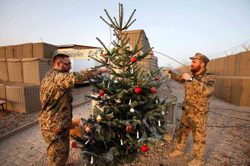 German Bundeswehr army soldiers decorate a fir tree imported from Germany for Christmas eve in the army camp in Kunduz